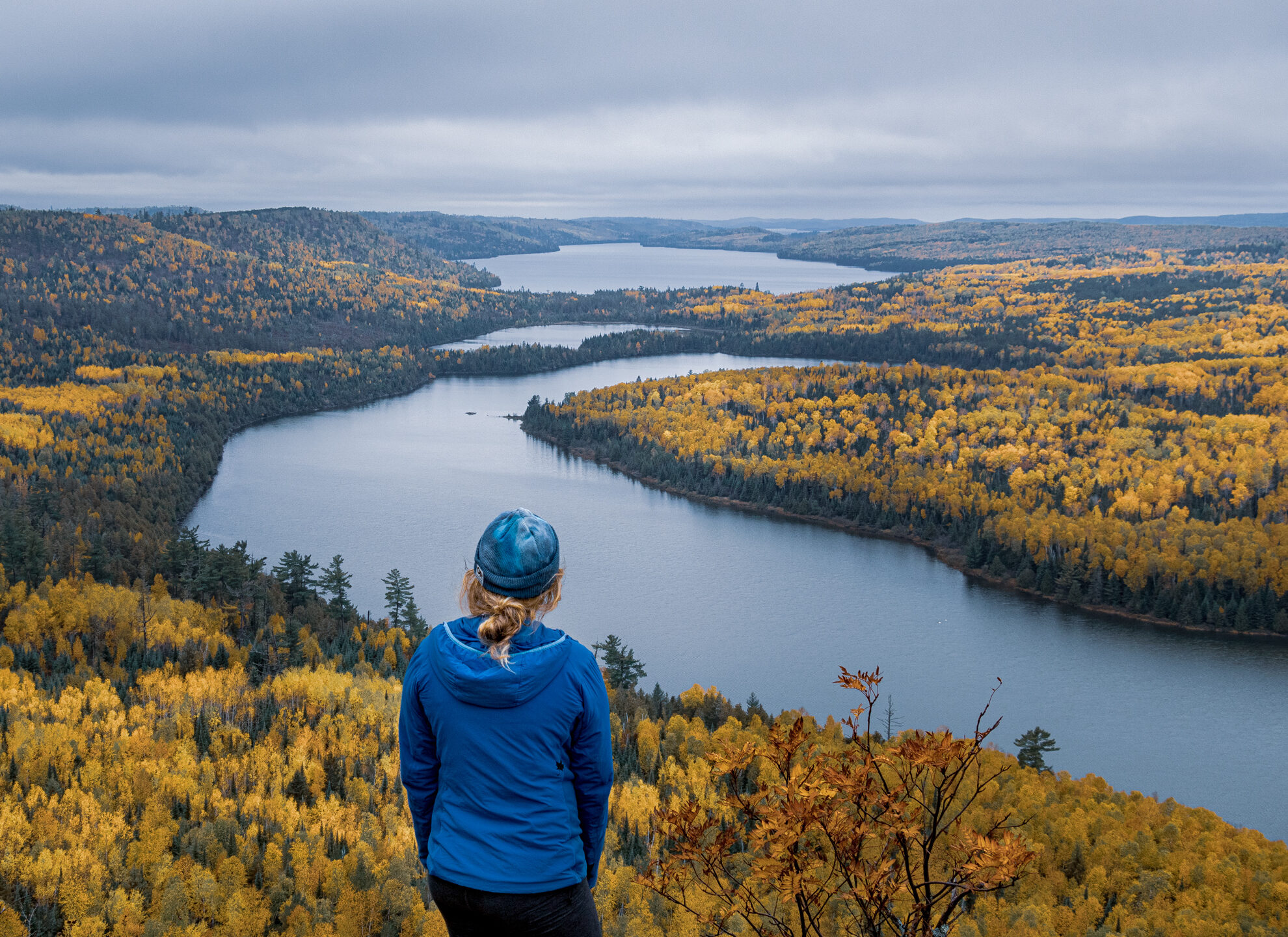 fall color spots in Northern MN for Instagram / Photography Rose Lake Cliffs on the Border Route with a hiker taking in the scenery