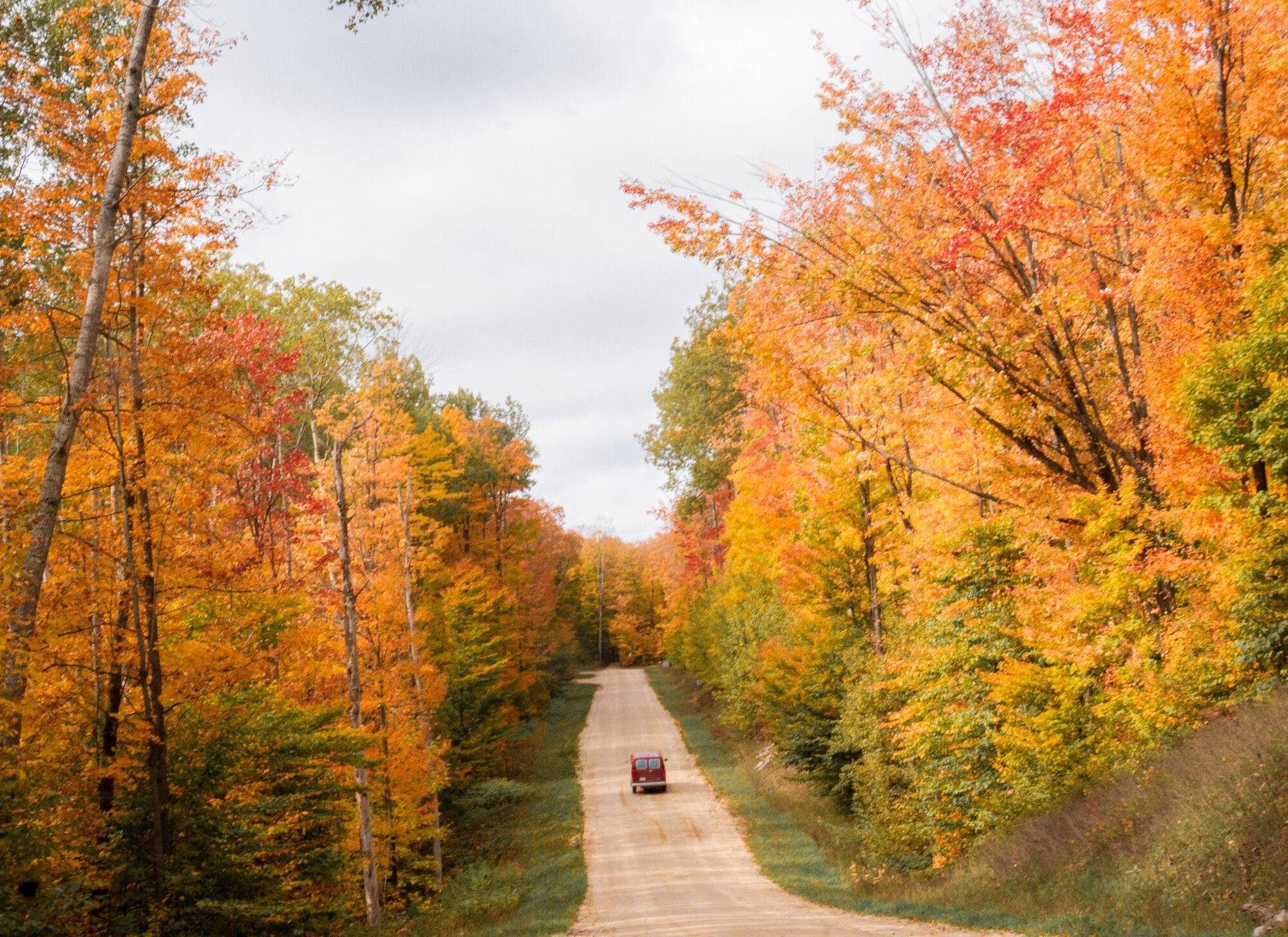 Image of a van on backgrounds on a road trip near Lake Michigan in full fall foliage